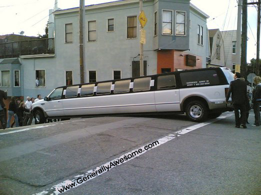 Stretch Limo SUV goes over a bump and gets stuck.  This photo is pretty funny, and I bet the wedding party was not planning on this!